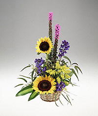 A basket arrangement of bright flowers