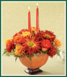 Celebrate a Happy Thanksgiving Day and place this splendid centerpiece on your table. Seasonal red rover, bronze and butterscotch poms, and 