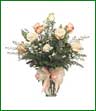 One dozen pink and white roses arranged in a glass vase.