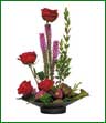 Red roses and purple liatris uniquely dislayed in a contemporary arrangement.