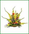 A colorful basket arrangement of gladiolus, carnations, pompons, gerbera and more in yellow, red, purple and bronze.