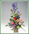 A colorful mixed bouquet of delphinium, roses, viburnum, standard carnations, monté casino asters, alstroemeria and yarrow.