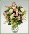A posy vase of miniature carnations, spray roses and solidaster.