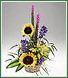 A natural basket of solidaster, liatris, sunflowers, delphinium and foliage.