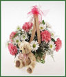 A baby girl themed basket of pink carnations, white daisy spray mums and gypsophila with a plush teddy bear.