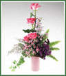 Four pink Fantasy roses,  purple statice, monté casino asters and limonium . Shown in pink vase, but vase color may vary.