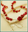 A rosary of fresh red roses Appropriate for funeral home.