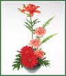 A stylized design of lilies, gerbera and carnations in vibrant oranges and reds with decorative foliage.
