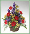 A traditional basket of primary-colored gerbera, delphinium, alstroemeria and solidago.