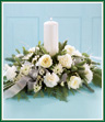 Set a gracious table with this elegant centerpiece of winter white flowers. All white carnations, roses, statice and cushion pompons are enhanced by an assortment of Christmas greens. A 9