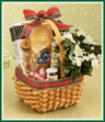 Two gifts in one! This pretty handled basket is trimmed with plaid ribbon and holds a snowy white azalea on one side. The other half is filled with an assortment of gourmet goodies such as cheese, crackers, and chocolates.