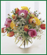Bursting forth with dazzling spring colors, this bouquet of red-tipped tulips with pretty pink and yellow roses will make their day. Arranged in a glass bubble bowl with monte casino aster and Queen Anne's lace, this bouquet is a great gift to celebrate any occasion.
