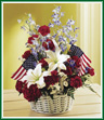 Time to decorate for those red, white, and blue holidays! This basket of white Asiatic lilies, blue belladonna, and red carnations is sure to add a festive touch to your home.
