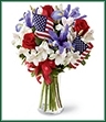 The Unity Bouquet sparks the hearts of all Americans with its patriotic beauty and dazzling color. Bright red roses mingle with blue iris arranged amongst white Peruvian lilies and assorted greens. Accented with two American Flags and a red, white and blue ribbon, this stunning bouquet arrives arranged in a clear glass vase to create a gorgeous way to celebrate our Independence Day.
