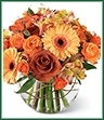 The Natural Elegance Bouquet ushers in the beauty and bounty of the Autumn season with abundant color mimicking the grandeur of this special time of year.  Lush Leonidas Roses, orange spray roses, golden gerbera daisies, and peach Peruvian Lilies are perfectly arranged in a clear glass bubble bowl vase to create a striking sentiment of gratitude and warmth.
