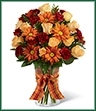 The Golden Autumn Bouquet exudes the warmth and comfort of the harvest season with each colorful bloom. Peach spray roses, burgundy mini carnations, butterscotch chrysanthemums and lush greens are arranged beautifully in a classic clear glass vase accented with an orange plaid ribbon around the neck, creating a truly wonderful bouquet that will send your sweetest sentiments to your special recipient for a fantastic fall. 