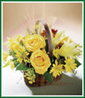 Bright yellow roses, lilies and daisy pompons reign in a rich, natural basket. Seeded eucalyptus adds soft color and fragrance. A bright and colorful arrangement to celebrate a special event - or simply the approach of autumn. Style of basket may vary.