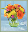 Pick a day - any day - to tell someone how special they are to you. Send them this exuberant, brightly colored bouquet of orange Gerbera daisies, yellow poms, hot pink mini carnations and vivid green button poms in a sleek, beaded green glass vase. Guaranteed to bring a smile!