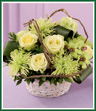 A study in green - jade roses, pistachio carnations, green dendrobium orchids and green spider chrysanthemums. All are nestled between ti leaves and hugged by grapevines in a whitewash bamboo basket. A lovely arrangement to send for any occasion. Style of basket may vary.