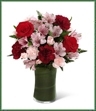 The Love in Bloom Bouquet is the perfect expression of sweet affection and adoration. Rich red roses, burgundy carnations, pink Peruvian lilies, pink mini carnations and lush greens are gorgeously arranged in a clear glass vase to convey your most heartfelt emotions. 