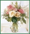 Rare beauties in a refined setting. A vase of intriguing cream and white roses with pink snapdragons and pink carnations will spark their love for you. Style of vase may vary.