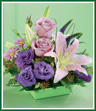 A pink Asiatic lily and two lavender roses are the stars in this stylish design. Lavender daisy poms and vibrant purple lisianthus comprise the supporting cast. All are arranged with purple statice and seeded eucalyptus in a lime green square bowl. Sure to be applauded as a gift for any occasion. Style of container may vary.